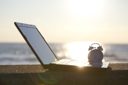 Laptop and alarm clock
