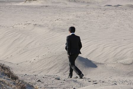 Businessman walking the desertの写真素材