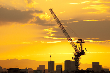 Construction site crane and sunsetの写真素材