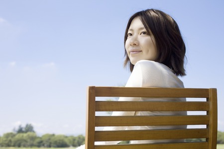 Woman sits on a Chairの写真素材