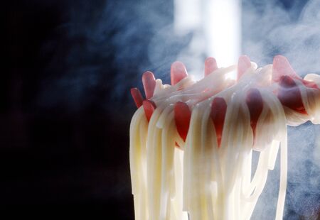 Lift the boiled fresh spaghetti steamingの写真素材