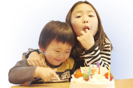 Children to eat a piece of cake secretlyの写真素材