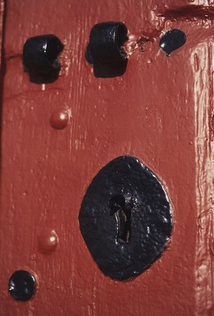 Keyhole of red doorの写真素材
