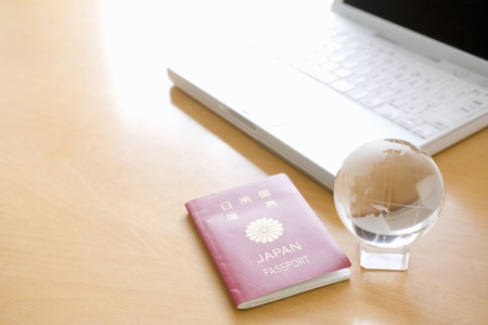 Laptop and passportsの写真素材