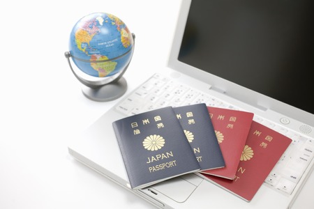 Laptop and passportsの写真素材