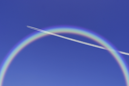 Contrail and rainbowの写真素材