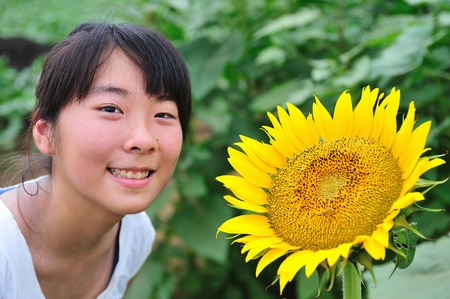 A girl and a sunflowerの写真素材