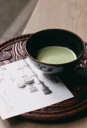 Matcha and article chiseled in hardwood and repeatedly lacquered in black and vermilion