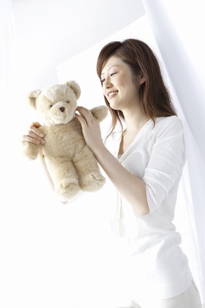 Woman holding stuffed animalの写真素材