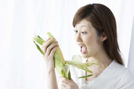 Women with cornの写真素材