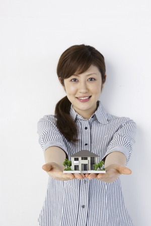 Women with women with a model of the houseの写真素材