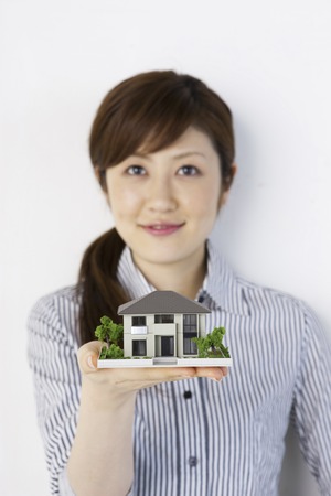 Women with women with a model of the houseの写真素材