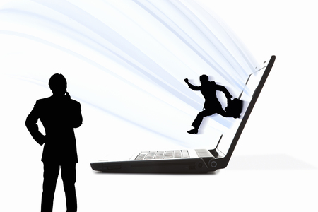 Businessman jumping out from laptop screenの写真素材