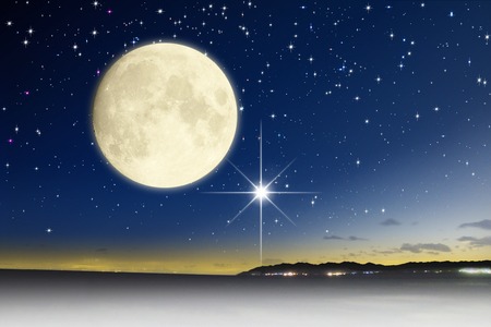 Starry sky and the moonの写真素材