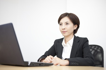OL to face with the laptopの写真素材
