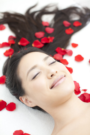 Petals of roses and womanの写真素材