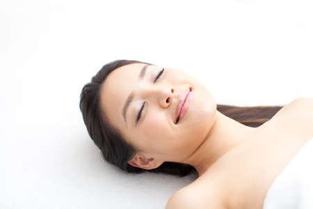 Woman lying in bedの写真素材