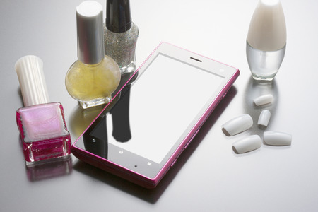 Smart phone with nail polishの写真素材
