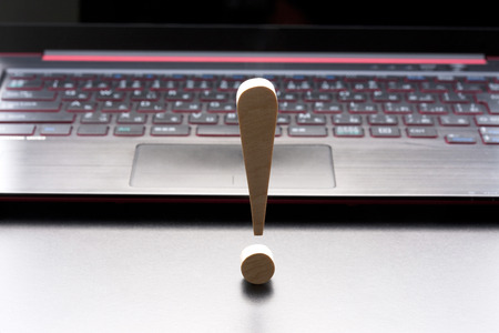 Surprised mark and notebook computerの写真素材