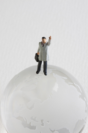 Globe and businessman miniatureの写真素材