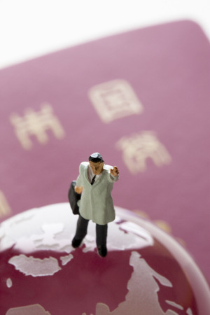 Businessman of miniature and passportの写真素材