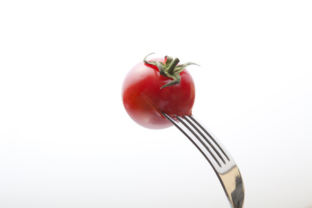 Tomatoes stabbed to forkの写真素材