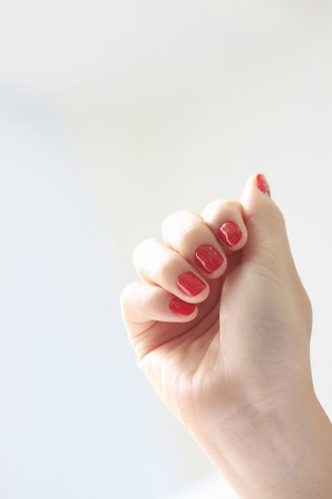 Woman with red nail polishの写真素材