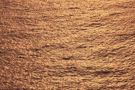 Water surface of sunsetの写真素材
