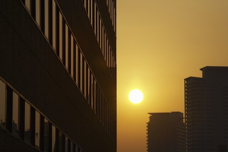 Sunset over the valley of the buildingの写真素材