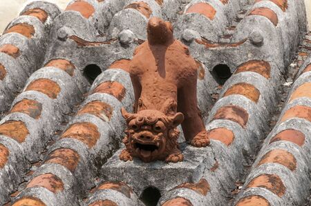 Shisa that sitting on the roofの写真素材