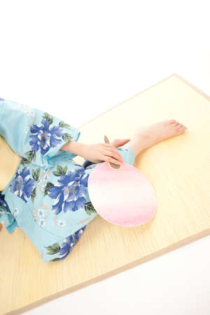 yukata women with sitting fanの写真素材