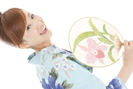 Yukata women flexing in the fanの写真素材