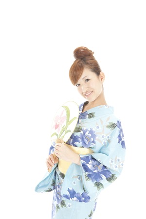 Yukata women flexing in the fanの写真素材