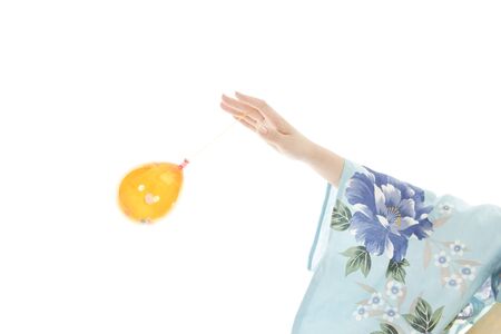 Hand of yukata woman with a water balloonの写真素材