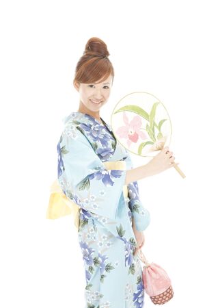 Yukata women flexing in the fanの写真素材