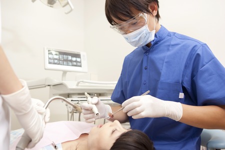 Male dentist for the treatment of female patientsの写真素材