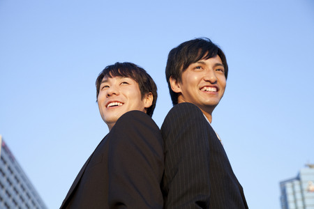 Businessman two people who look up at the skyの写真素材