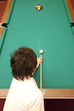 From behind the men who hit the break shotの写真素材