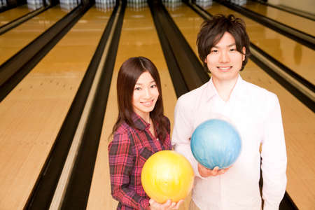 Men and women with a bowling ballの写真素材