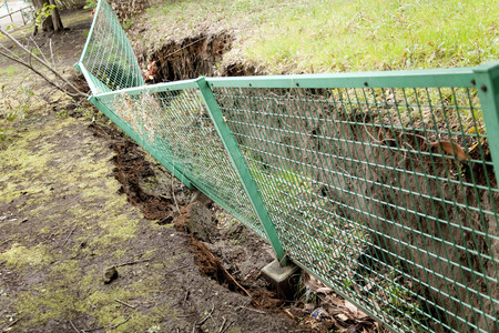 Fence that was depressed by liquefactionの写真素材