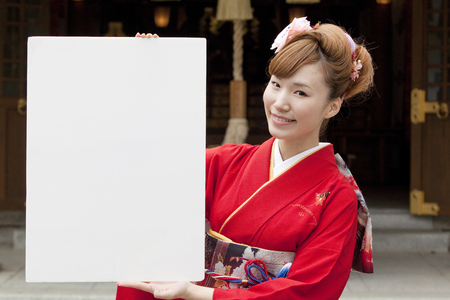 Women kimono figure with a white boardの写真素材