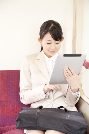 OL touch Tablet PC in the trainの写真素材