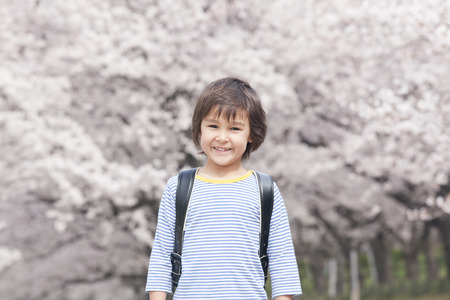 Boy smiling cherry in backの写真素材