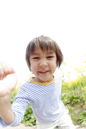 Boy smiling in the rape fieldsの写真素材
