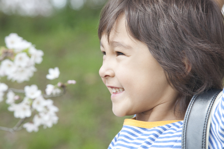 Smiling under the cherry boysの写真素材