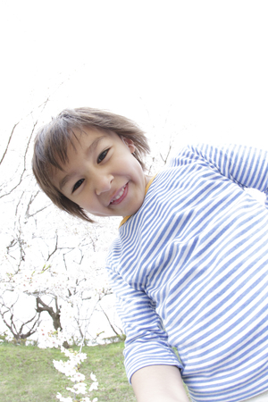 Smiling under the cherry boysの写真素材