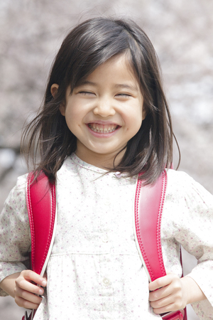 Smiling under the cherry blossom girlの写真素材