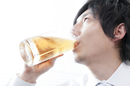 Businessman drinking beerの写真素材