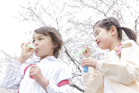 Children playing with bubblesの写真素材