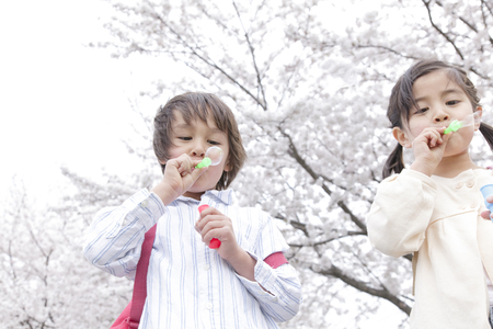Children playing with bubblesの写真素材